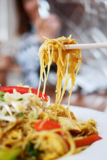 holding malaysian seafood noodles